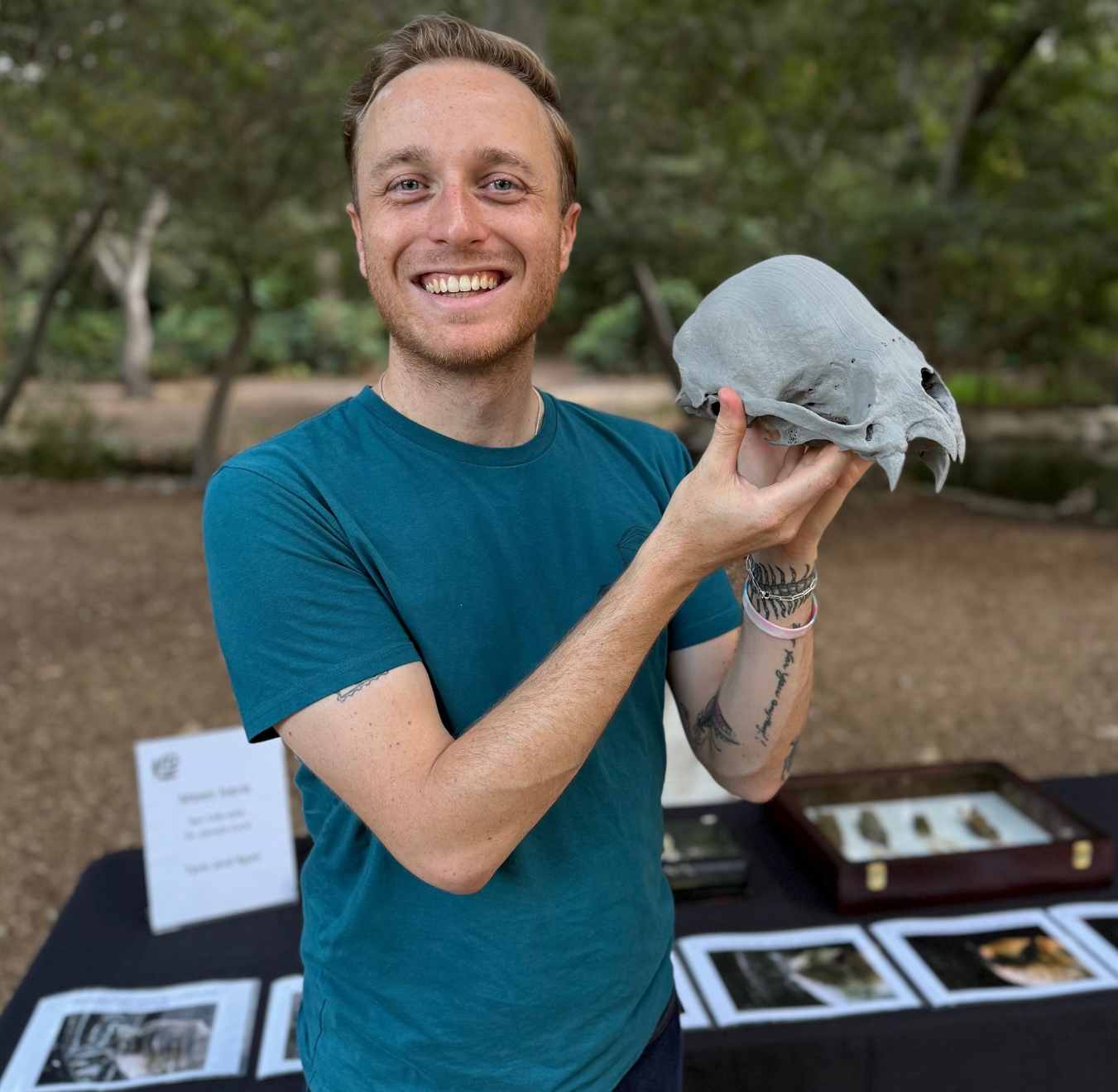 Joey Curti light skinned male presenting person holding an animal skull